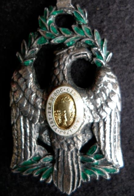 A medallion with an eagle holding an olive branch https://commons.wikimedia.org/wiki/File:Order_of_cincinnati.jpg